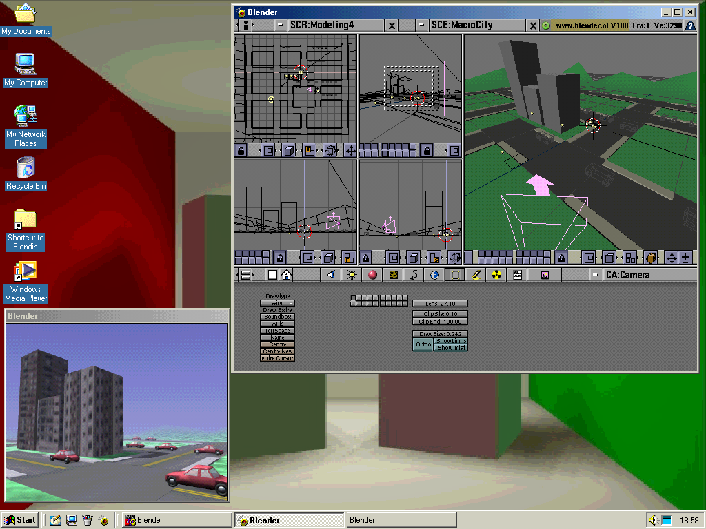 Blender 1.80 running on Windows ME. A scene consisting of streets, cars and a couple buildings are present