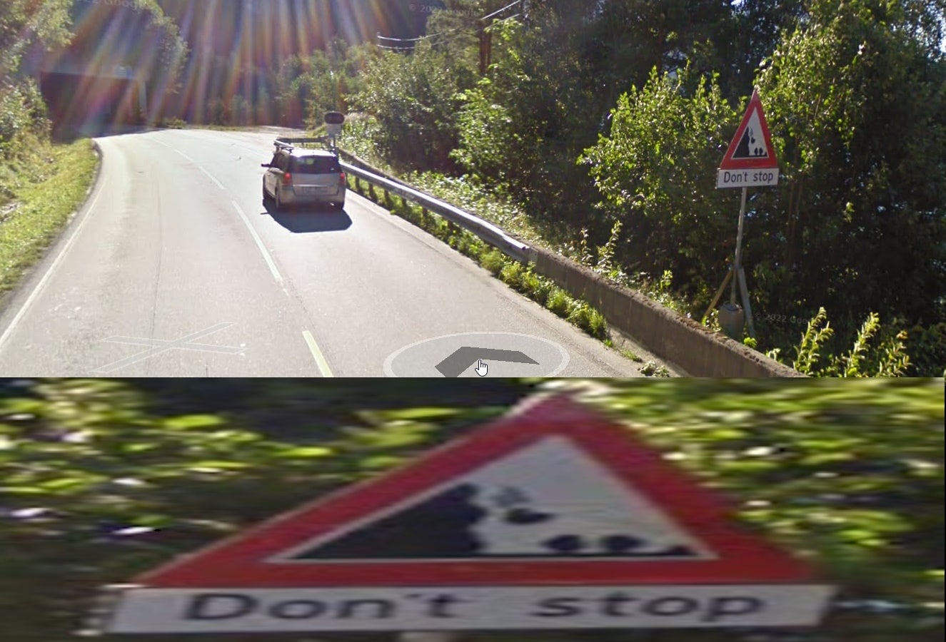 Google streetview picture from the dangerous road, showing a road sign warning about falling rocks and to 'Don't Stop'